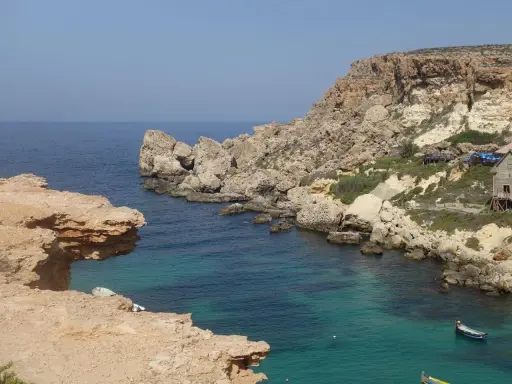 Malta w grudniu: skaliste wybrzeże, turkusowa woda i łodzie. Idealna temperatura na zwiedzanie!