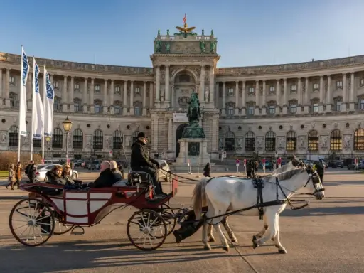 Wiedeń co zobaczyć: przejażdżka dorożką przed Hofburgiem, imponującym pałacem cesarskim.