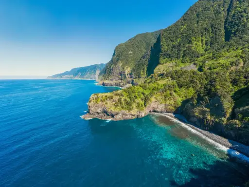 Grüne Berge treffen auf türkisfarbenes Meer. Ein perfekter Ort, um Madeira zu erleben.