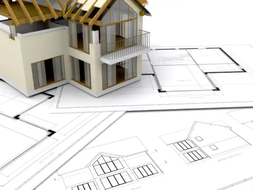 Model domu na planach architektonicznych. Zastanawiasz się, ile trwa budowa domu? To zależy od wielu czynników, ale zaczyna się od projektu.