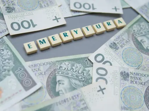 Polskie banknoty 100 zł i kafelki z napisem "EMERYTURA".