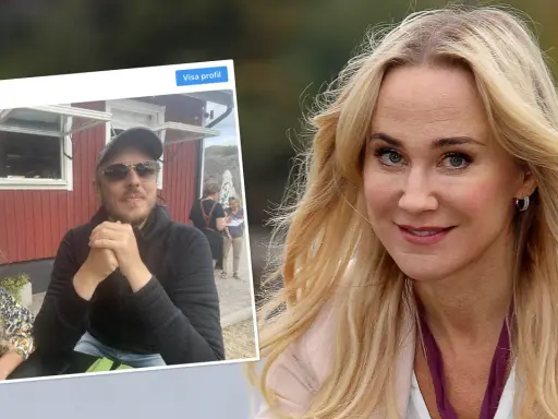 Anja Lundqvist med sin partner framför en röd byggnad.
