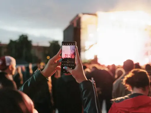 Publik njuter av en konsert i Skellefteå, Sverige. En person filmar scenen med sin mobiltelefon.