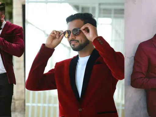 Three men sport stylish burgundy and red blazers. One adjusts his hair, another his sunglasses, and the third checks his phone.
