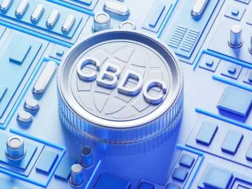 Moneta z napisem CBDC na tle obwodów drukowanych. Zastanawiasz się, cbdc co to? To cyfrowa waluta banku centralnego.