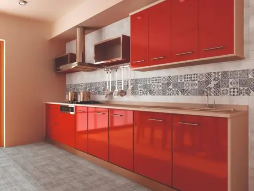 Cocina moderna con gabinetes rojos brillantes y una cenefa de azulejos con patrones geométricos en blanco y negro.