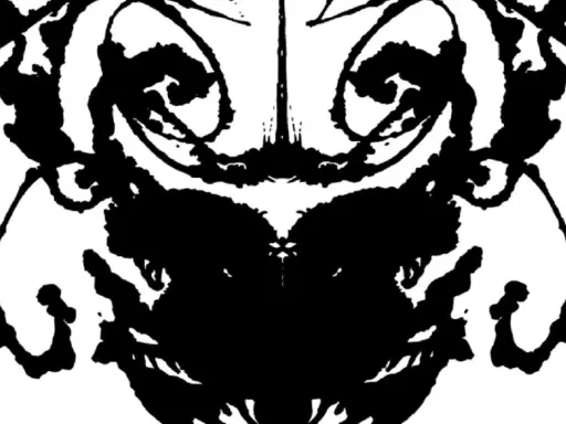 Symetryczna plama tuszu, przypominająca twarz lub zwierzę, używana w testach psychologicznych.