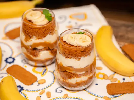 Pyszny deser banoffee w szklankach, warstwowo ułożony z bananów, kremu i pokruszonych ciasteczek. Idealny przepis na słodką chwilę.