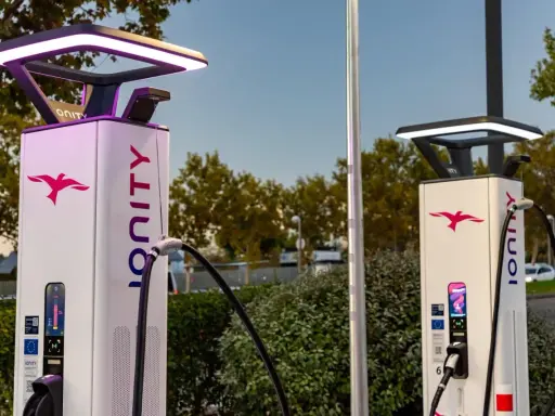 Dos modernas gasolineras eléctricas con el logo de Ionity y luces LED.