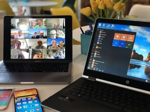 Mehrere Personen winken in einem Videoanruf. Ein schneller Internetanschluss macht solche Treffen möglich.