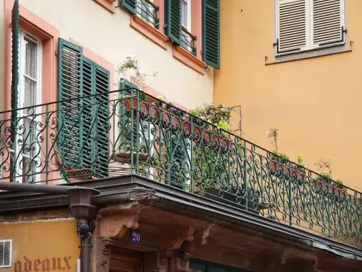 Kto odpowiada za przeciekający balkon? Zobaczcie ten stary budynek z ozdobną balustradą i rynnami, które mogą być przyczyną problemu.