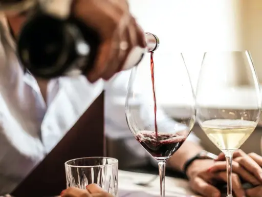 Servicio de vino tinto en la finca la malcriada dulce. Copas de vino y agua en una mesa elegante.