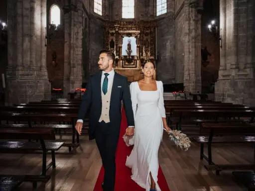 Novios sonriendo y caminando por el pasillo de una iglesia, listos para sus votos matrimoniales divertidos.
