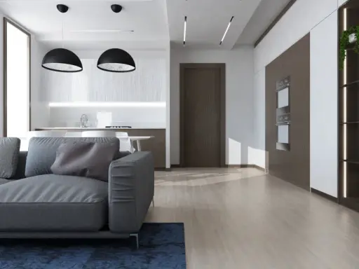 Soggiorno moderno con divano grigio, cucina a vista e scaffalatura illuminata. Ottime idee controsoffitto open space per definire gli ambienti.