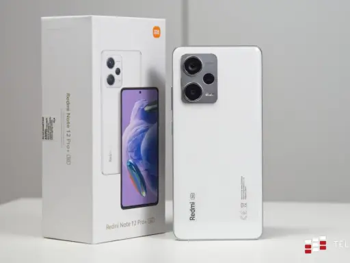 Biały smartfon Xiaomi Redmi Note 12 Pro+ 5G obok swojego opakowania.