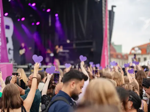 Publik med lila hjärtan och mobiler fångar en konsertupplevelse under ett av Göteborgs evenemang.