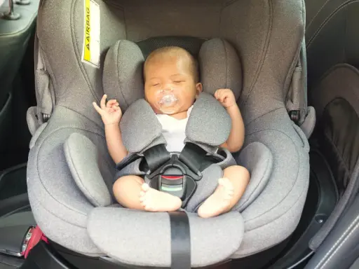 Bebé dormido en su silla de coche, un paso clave para como acostumbrar a un bebé al coche y viajar seguros.