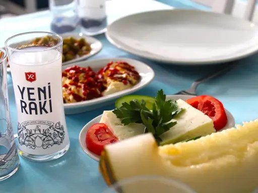 Ein Glas Yeni Raki, Käse, Tomaten und Melone – so trinkt man Raki in geselliger Runde.