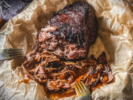 Saftiges Pulled Pork, perfekt für Ihre nächsten Grillrezepte mit Fleisch. Zart und geschmackvoll, mit einer köstlichen Sauce übergossen.