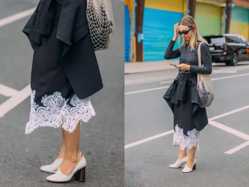 Elegancka koronkowa spódnica stylizacje z czarną marynarką i siatkową torbą. Kobieta w okularach przeciwsłonecznych i szarej bluzce z długim rękawem.
