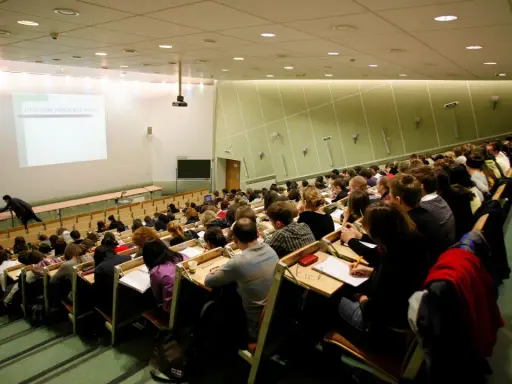 Wykład w auli uniwersyteckiej. Studenci siedzą w rzędach, słuchając wykładowcy. Może to być jeden z najmniej obleganych kierunków studiów, skoro sala jest tak pusta.