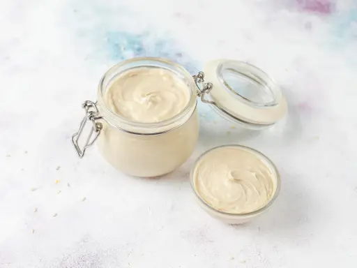 Crème pâtissière onctueuse dans un bocal et un bol. Parfait pour une recette de crème pâtissière facile et rapide.