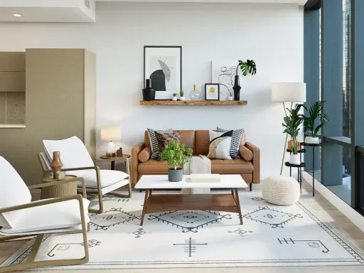 Salón moderno con sofá de cuero, sillones blancos y alfombra geométrica. Dos focos empotrados sin falso techo iluminan la estancia.