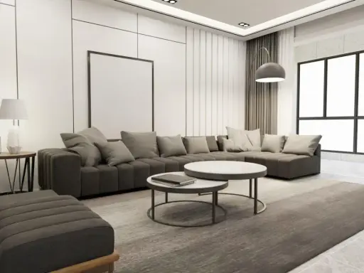 Nowoczesny salon z szarą sofą, dwoma stolikami kawowymi i dywanem. Wnętrze emanuje **quiet luxury**, gdzie każdy element jest dopracowany w subtelny sposób.