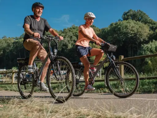 Para, jadąca na rowerze dla grubasa, cieszy się przejażdżką po malowniczej ścieżce.