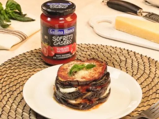 Deliciosas berenjenas a la parmesana apiladas, con queso fundido y salsa de tomate casera.