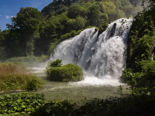 Cascata maestosa, un vero spettacolo per chi ama i sentieri tra le cascate più belle. Vegetazione lussureggiante e acqua impetuosa.