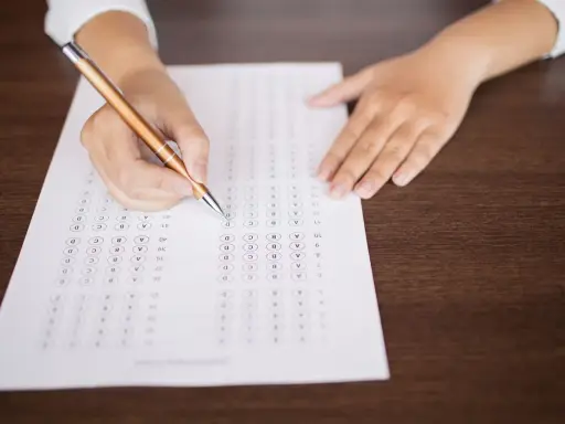 Persona completando un examen de opción múltiple, preparándose para el teórico carnet C.