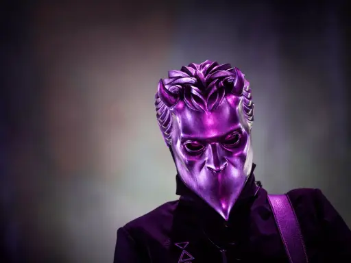 En av Ghost medlemmar utan mask, med en metallisk lila mask som täcker ansiktet.