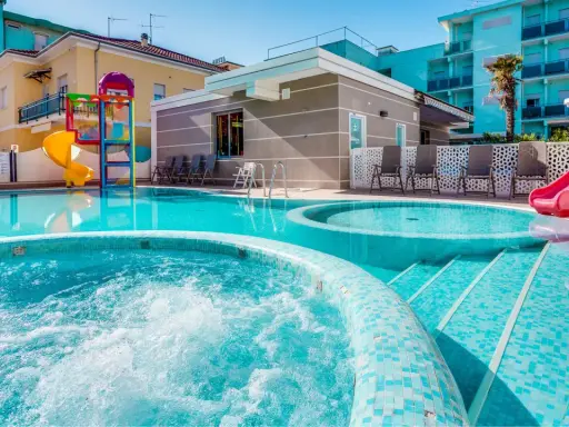 Piscine scintillanti e scivoli colorati in un adriatico family village, perfetti per il divertimento di tutta la famiglia.
