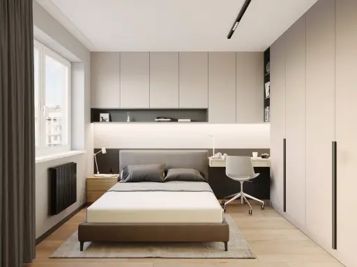 Dormitorio moderno con cama, escritorio y armarios empotrados. Ideas de almacenamiento de dormitorio para maximizar el espacio.