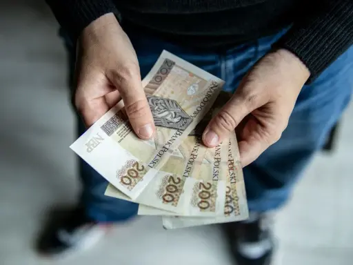 Dłonie trzymają banknoty 200 zł. Czy to odpowiedź na pytanie: 800 plus dla kogo?