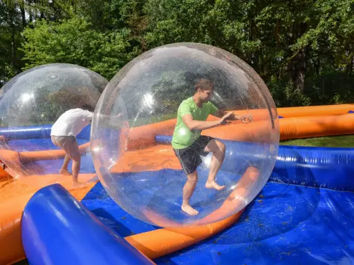 Świetne pomysły na team building: ludzie w dmuchanych kulach na wodzie, śmiech i zabawa gwarantowane!