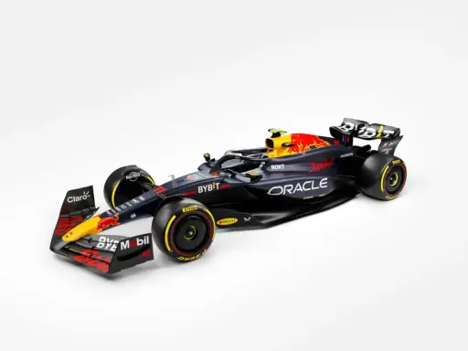 El coche de **Red Bull F1** en negro y azul oscuro, con detalles en rojo y amarillo, listo para la velocidad.