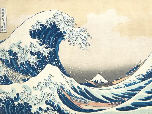 A massive blue wave crests, threatening boats below. In the distance, Mount Fuji, a peak from the "Thirty-six Views of Mount Fuji" series, stands serene.
