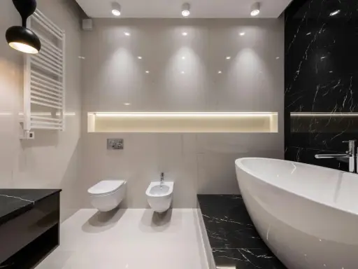 Radiador toallero blanco colgado en pared junto a un inodoro y bidet, ideal para baños modernos.