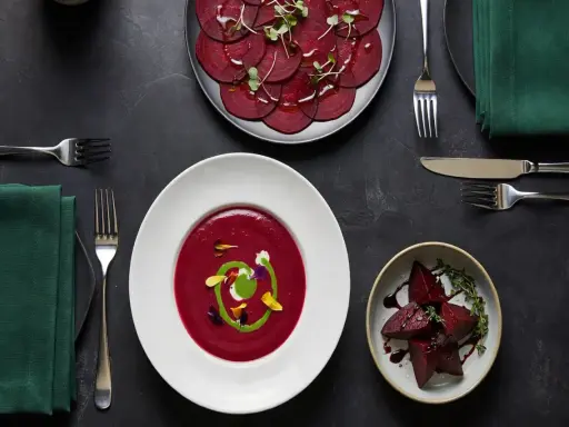 Un repas gastronomique met en vedette la betterave rouge sous diverses formes : en carpaccio, en velouté onctueux et en morceaux rôtis.