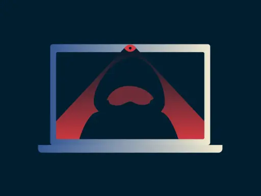 Ein Laptop mit einer roten Linse, die einen Hacker im Kapuzenpullover im Inneren beleuchtet. Das Bild symbolisiert das **webcam hacken**.