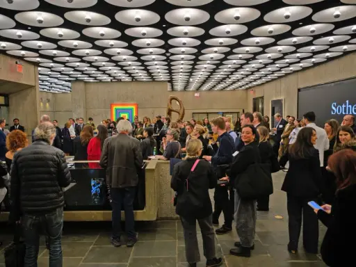 A crowd gathers at a Sotheby's event, a vibrant scene in the contemporary art market.