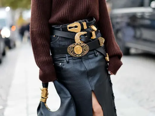 Layered black belts with ornate gold buckles make a bold statement, proving belts are definitely in style.