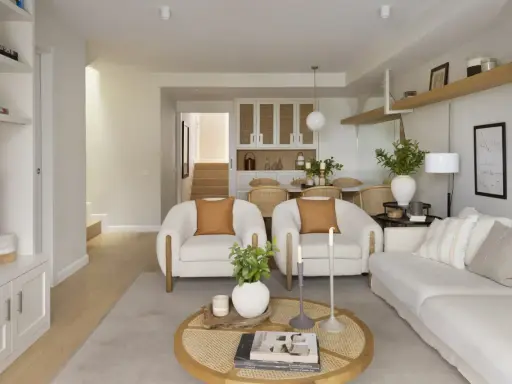 Salón rectangular dos ambientes con sofás blancos, sillones de borrego y mesa de centro de ratán.