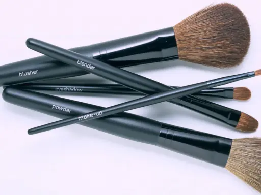 Un conjunto de brochas de maquillaje negras etiquetadas como "blusher", "blender", "eyeshadow", "powder" y "make-up". Aprende como limpiar brochas de maquillaje para mantenerlas en perfecto estado.