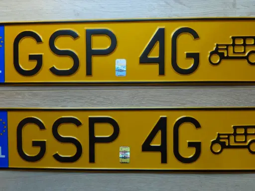 Dwie żółte tablice rejestracyjne z napisem "GSP 4G" i wizerunkiem zabytkowego samochodu.