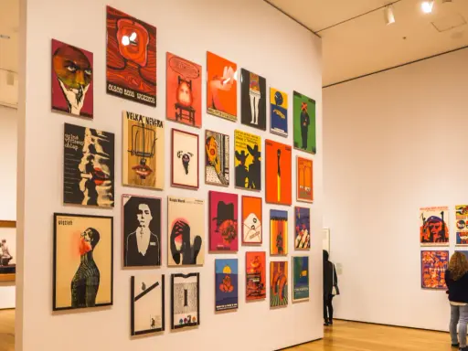 Vibrant posters adorn a gallery wall, showcasing diverse graphic design. This exhibition highlights some of the best art cities in the US.