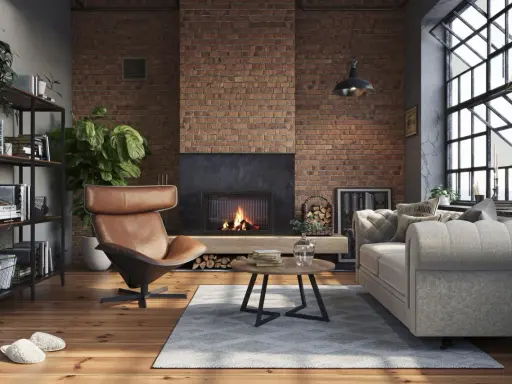 Przytulny salon w stylu loft. Ceglana ściana, kominek, skórzany fotel i wygodna kanapa – idealne salon loft inspiracje.