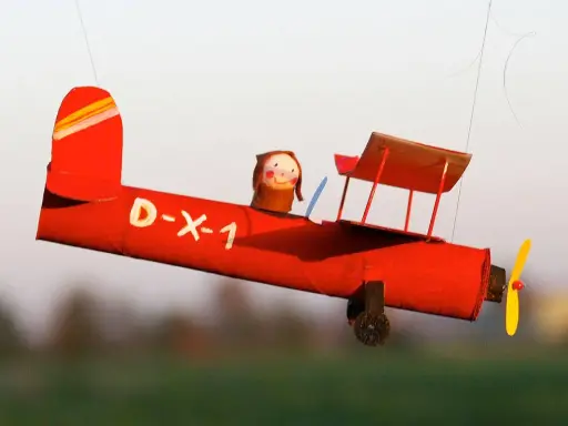 Rotes Bastel-Flugzeug mit Puppen-Pilot, D-X-1, fliegt. Eine tolle Vorlage zum Nachbasteln!